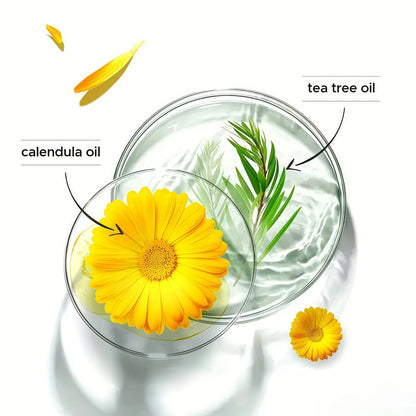Two glass containers with yellow flowers and green leaves labeled 'calendula oil' and 'tea tree oil' on a white background.